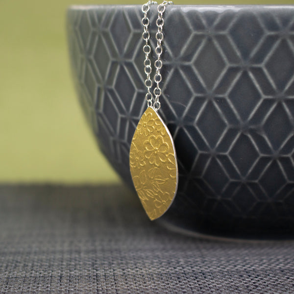 24k gold and silver flower patterned petal shaped pendant by Joanne Tinley Jewellery