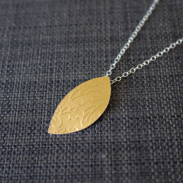 24k gold and silver oak leaf patterned petal shaped pendant by Joanne Tinley Jewellery