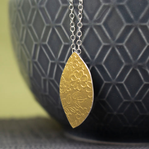 24k gold and silver flower patterned petal shaped pendant by Joanne Tinley Jewellery