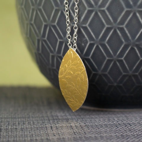 24k gold and silver leaf patterned petal shaped pendant by Joanne Tinley Jewellery