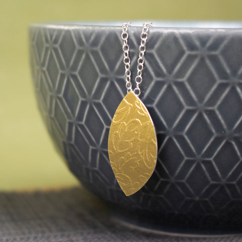 24k gold and silver oak leaf patterned petal shaped pendant by Joanne Tinley Jewellery