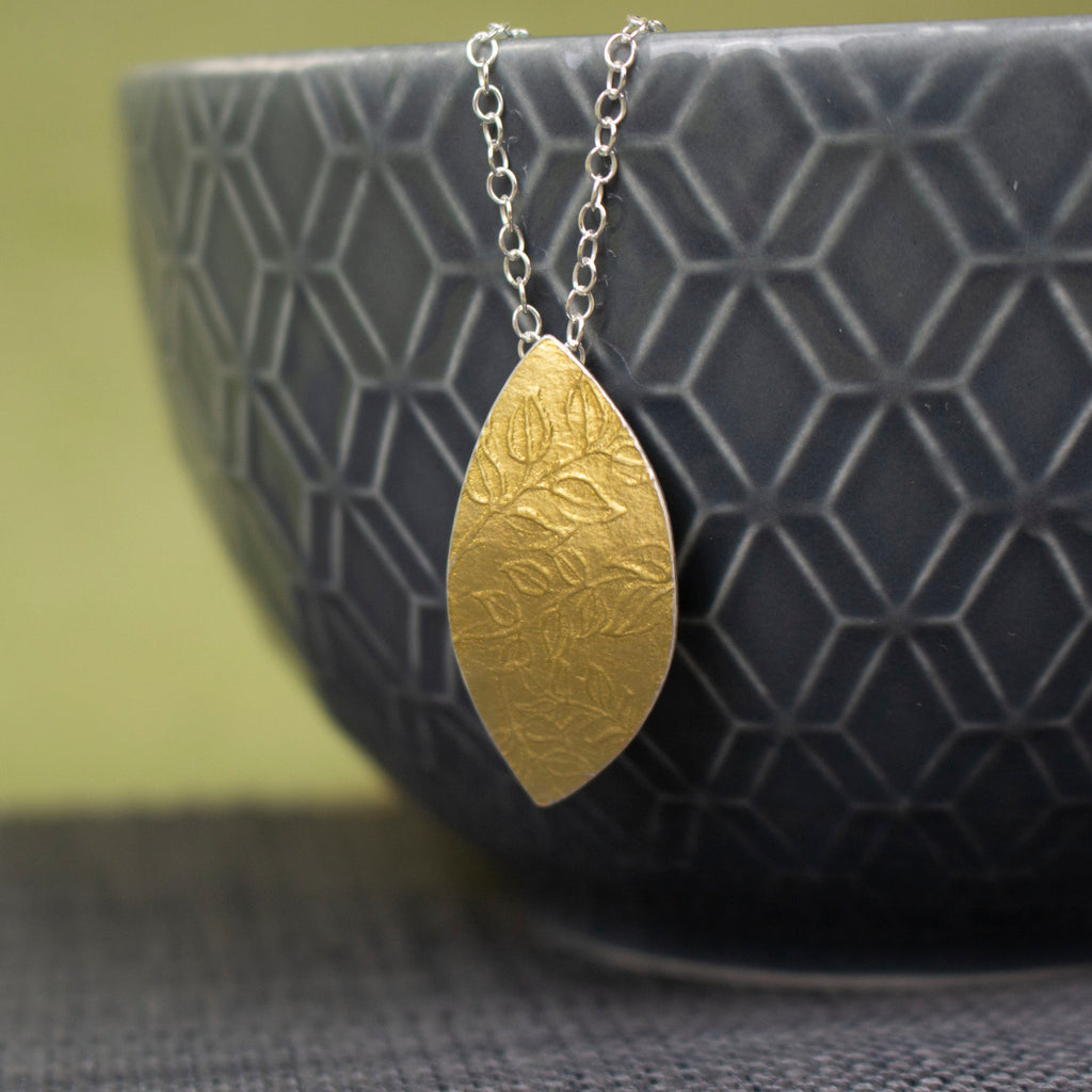 24k gold and silver leaf patterned petal shaped pendant by Joanne Tinley Jewellery