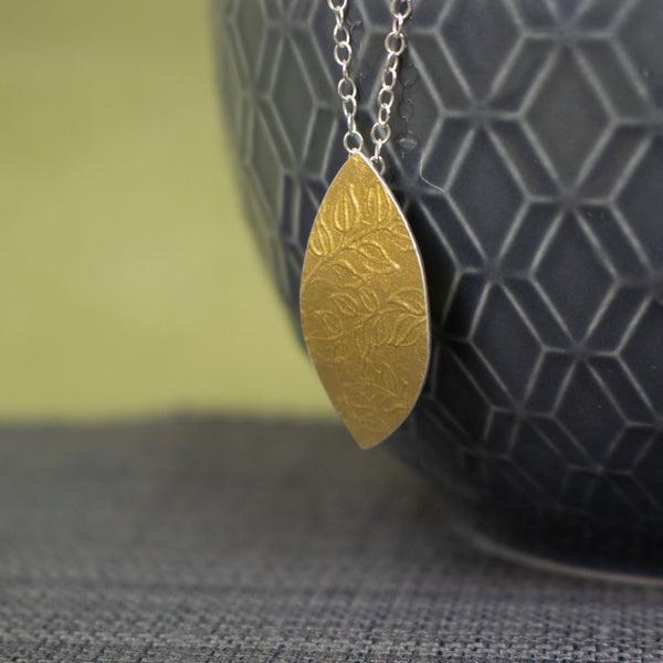 24k gold and silver leaf patterned petal shaped pendant by Joanne Tinley Jewellery