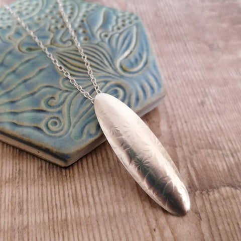 Oval sterling silver pendant with flowers pattern by Joanne Tinley Jewellery