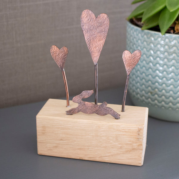 copper and oak handcrafted ornament featuring a running hare and hearts - Joanne Tinley Jewellery