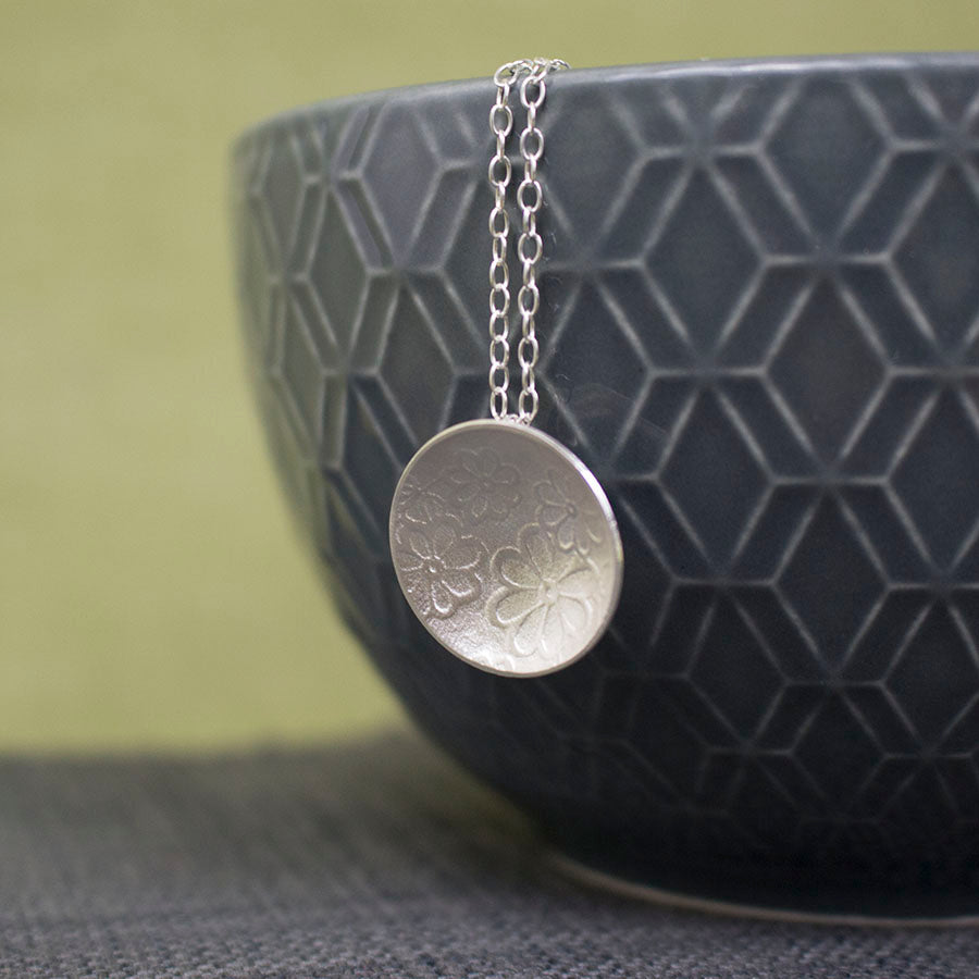 sterling silver flower disc pendant at Joanne Tinley Jewellery