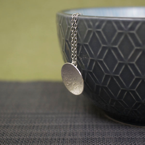 sterling silver flower disc pendant at Joanne Tinley Jewellery